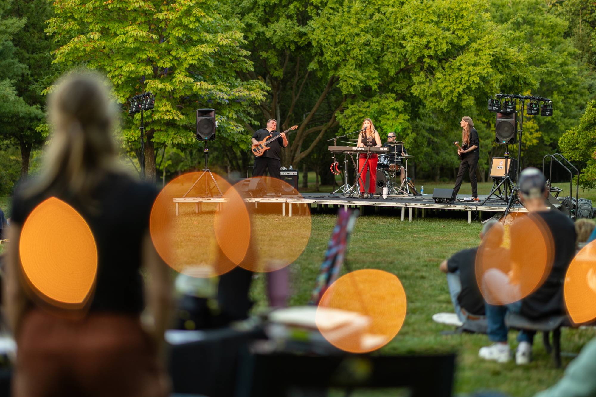 perform stands on stage singing while playing a piano outside